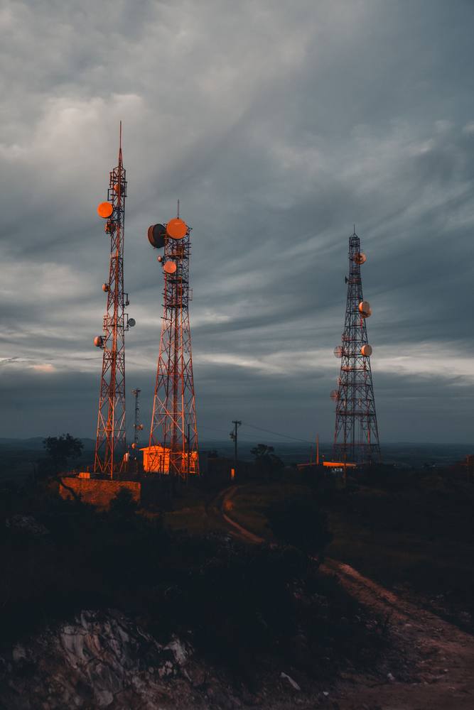 Telecom towers at dusk in a rural area